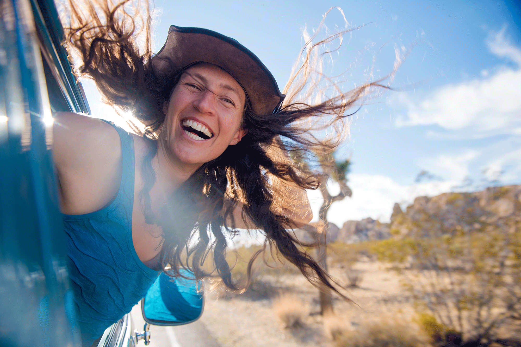 Photograph of Strong women hair flying out of window in Joshua Tree Ca