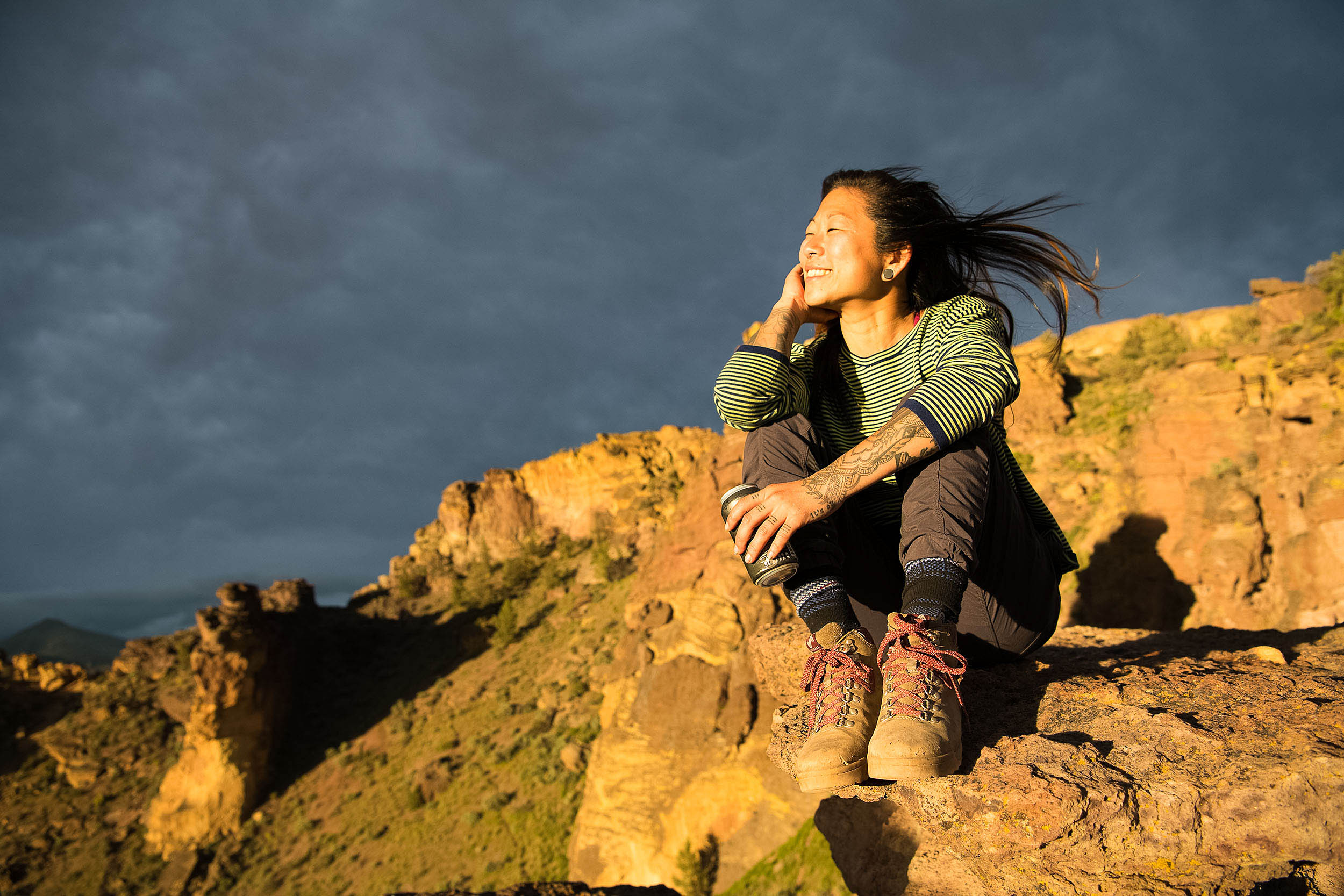 Asian women watches sunset outdoors at Smith Rock state park